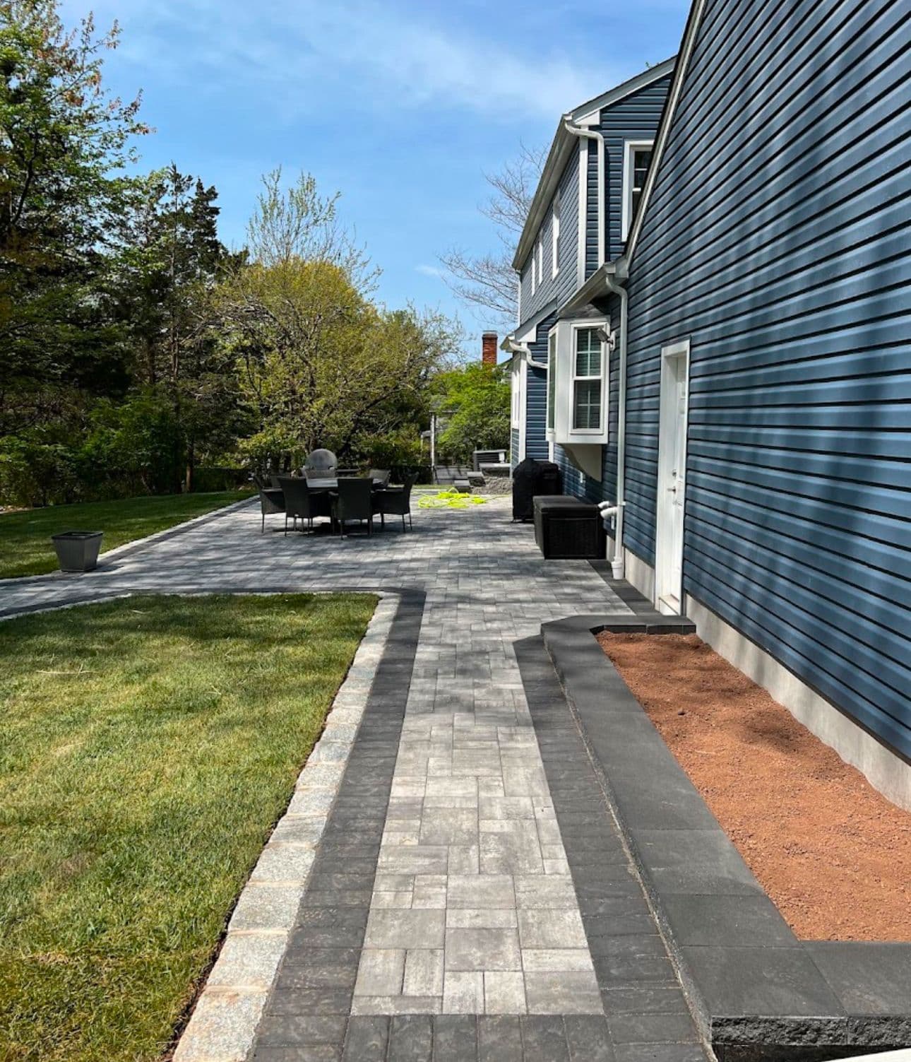 Elegant patio and stone walkway by Flawless